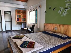a bedroom with a large bed in a room at Sai Homestay in Malvan