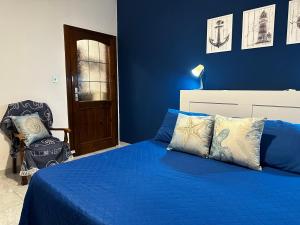 a blue bedroom with a bed and a chair at BluMare ForFamily in Gallipoli