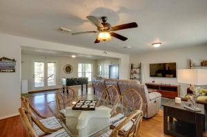 a living room with a couch and a ceiling fan at Spacious Livingston Home with Private Boat Dock in Livingston