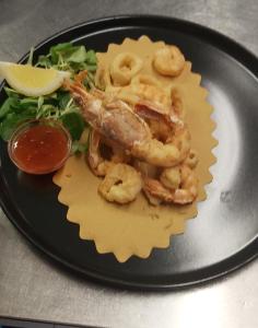 a plate of food with shrimp and a salad at Hotel Danieli La Castellana lago di Garda in Brenzone sul Garda