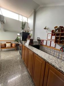 a kitchen with a counter top and a living room at Solar S.Bento in Santo Tirso