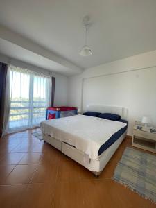 a bedroom with a bed and a large window at PLEASENT SUNSET in CESME-SITE SOLEY 17 in Çeşme +31 photos