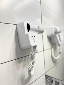 a phone hanging on a wall with a cord at RIMA Del Mar in Eforie Nord