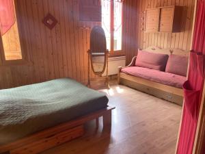 a bedroom with a bed and a bench in a room at Chalet Rekiano à Samoens - 5 pers in Samoëns