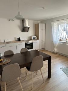 a kitchen with a table and chairs in a room at Appartment Moltke in Herbolzheim
