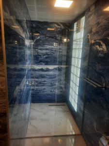 a bathroom with a shower with a painting on the wall at Huma Elite Hotel in Antalya