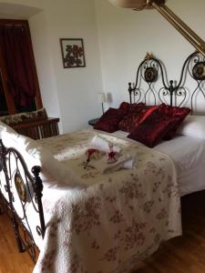 a bedroom with a large bed with red pillows at La Casa di Bacco B&B in Lerma