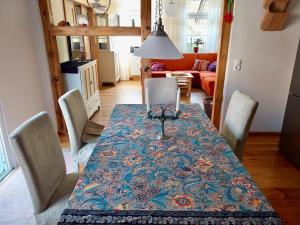 a dining room with a table with chairs and a couch at Ferienwohnung Mathilda in Waren