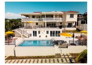 a large white house with a swimming pool at Sauna Pool Game Room Bliss in Rodney Bay Village