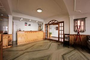 a large room with a large wooden floor and an open door at Goroomgo Kalra Regency - Best Hotel Near Mall Road with Parking Facilities - Luxury Room Mountain View in Shimla