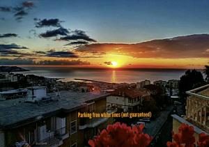 a sunset over a city with the words parking there mile lines just generated at Il Paradiso del Relax Chambres d'hotes Affittacamere room with sea view in Sanremo