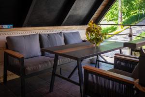 a couch and a table in a room at Uroczysko in Lesko