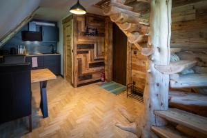 a room in a log cabin with a tree at Uroczysko in Lesko +74 photos