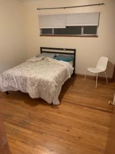 a bedroom with a bed and a chair in it at Pearl Cove in Santa Cruz