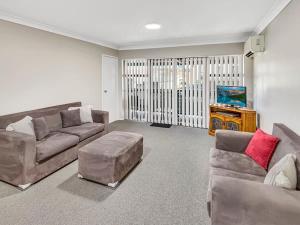 a living room with two couches and a tv at Glenmore Lodge - CBD Location, Hidden Gem in Dubbo