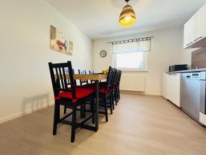 a dining room with a table and chairs in a kitchen at Apartma Jana in Žirovnica