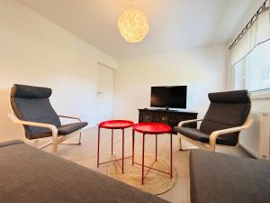 a living room with two chairs and a table and a television at Apartma Jana in Žirovnica