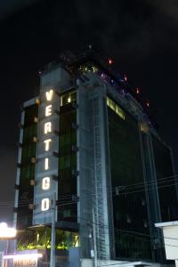 a tall building with the word hotel on it at night at Vertigo Hotel in Lagos