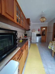 a kitchen with a yellow floor in the middle of it at Brisa do Mar in Vagos