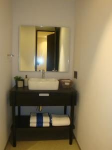 a bathroom with a sink and a mirror at Romance en Sail View Vallarta in Puerto Vallarta