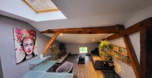 a living room with a ceiling with beams and plants at Gite au bord du Lot in Aiguillon