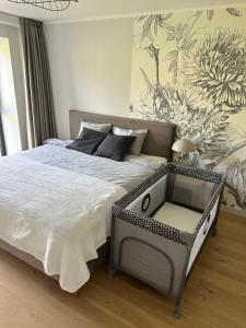 a bedroom with a large bed with a table at AC seaside apartments Albatross in Ķesterciems +15 photos