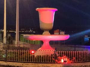 a large pink lighted monument in a city at night at Seaham in Weymouth