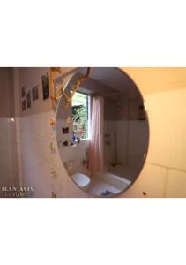 a mirror in a bathroom with a sink and a toilet at The Patnem villa in Canacona