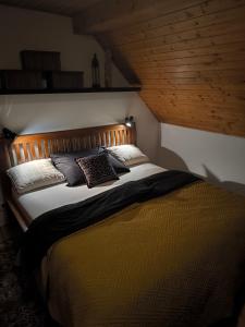 a bedroom with a large bed with a wooden headboard at chata ,,Na Brehu'' in Klokočov