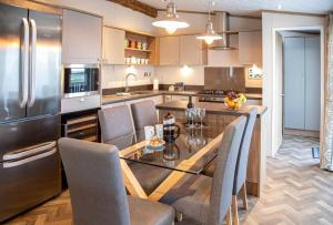 a kitchen with a table and chairs and a refrigerator at Stewarts Resort Lodge 16 in St. Andrews