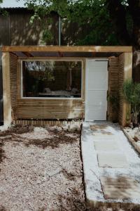 a garage with a white door in a yard at Le Chalet Tipi avec jacuzzi et jardin in Troyes