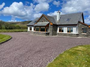 a house with a gravel driveway at Reenconnell Dingle in Dingle