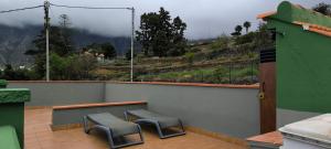 a balcony with two chairs and a view of a mountain at Casa Chemar in La Orotava
