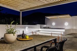 an outdoor dining area with a table and chairs at Casa Naturale in Skopelos Town