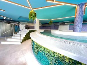 a swimming pool in a building with an aquarium at Hotel Spa Playa Langosteira by Adeloló in Finisterre
