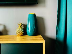 a blue vase and a pineapple sitting on a table at Luxury villa with breathtaking view & hot tub, middle of Golden Circle , Smart home lights & electronics for comfort in Reykholt