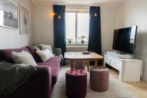 a living room with a couch and a table at Duveslätt B & B in Åskloster