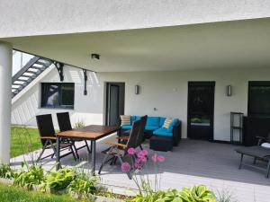 a patio with a couch and a table and chairs at peter@home 