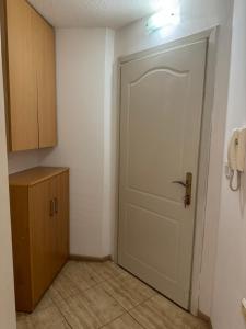 an empty room with a door and a telephone at Gold Apartment in Ohrid
