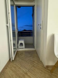 a door to a balcony with a view of the ocean at Gold Apartment in Ohrid