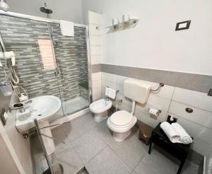 a bathroom with a toilet and a sink and a shower at Calvino Home in Trapani +33 photos
