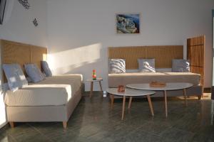 a living room with a couch and a table at Klados Studios & Apartments in Cherronisos