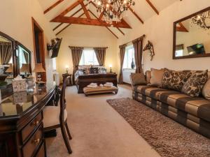 a living room with a couch and a piano at Linwood in Thornton