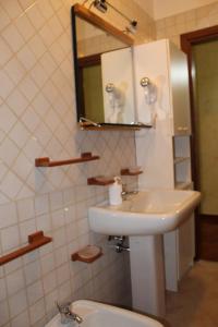 een badkamer met een wastafel, een spiegel en een toilet bij Sosta in Sila in Spezzano Piccolo