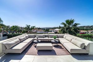 eine Couch auf einer Terrasse in der Unterkunft Villa Casiopea- Stunning holiday villa in Marbella in Marbella