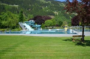 a water park with a water slide in a park at Alpenkönig in Zell am Ziller