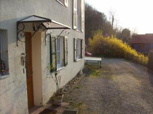 a building with a bench on the side of it at Haus Diana in Badenweiler +6 photos