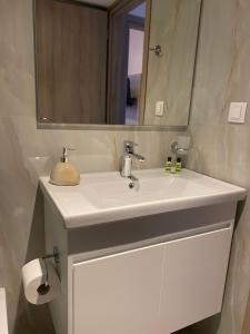 a bathroom with a white sink and a mirror at Soula Apartments & Studios in Palaiochora