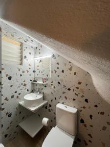 a bathroom with a toilet and a sink at Avra Boutique in Benitses