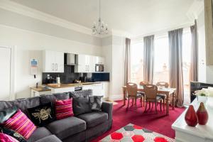 a living room with a couch and a table at Woodlands Holiday Apartments in Lytham St Annes